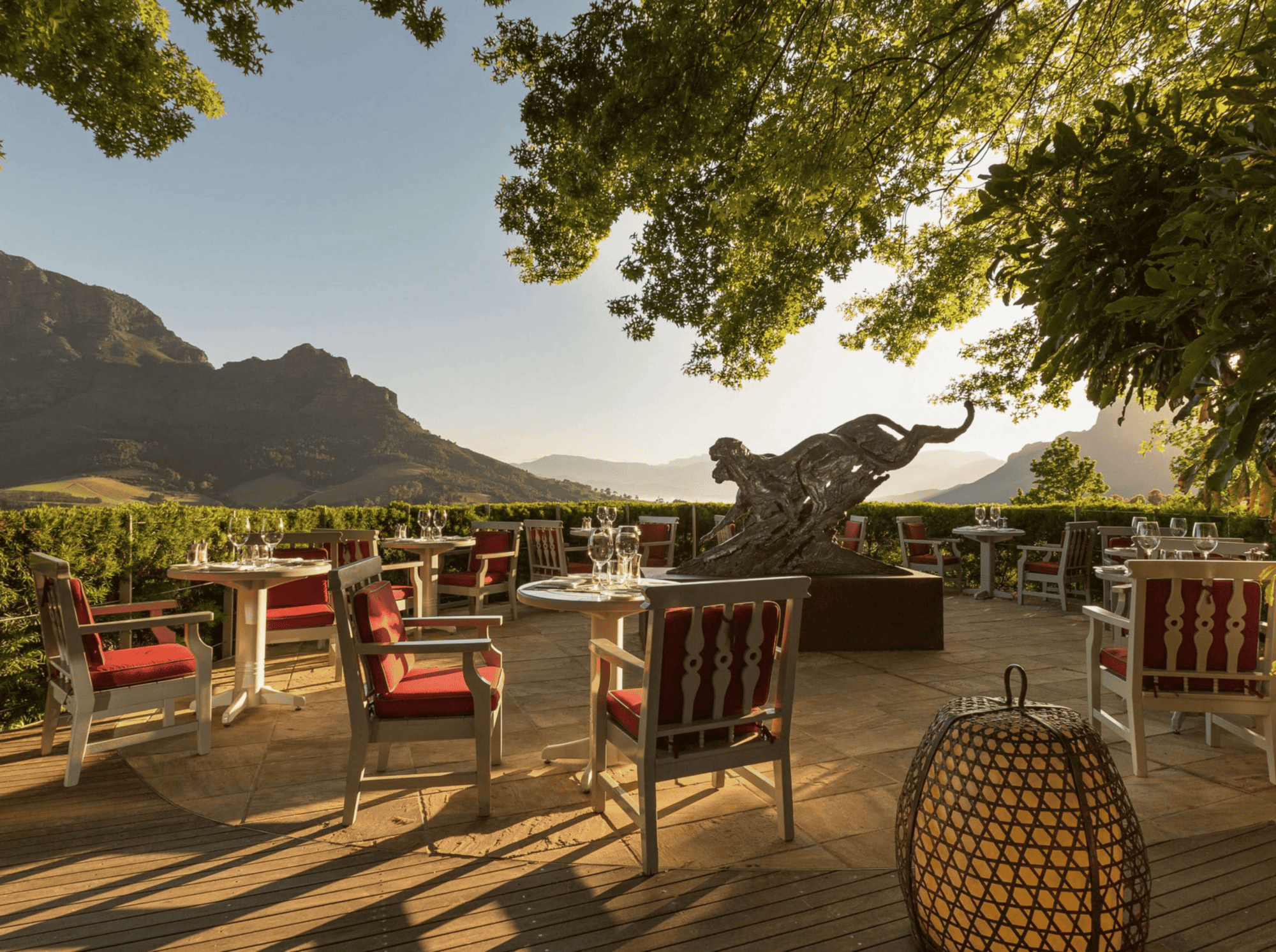 Outdoor dining patio with mountain views and abstract sculpture