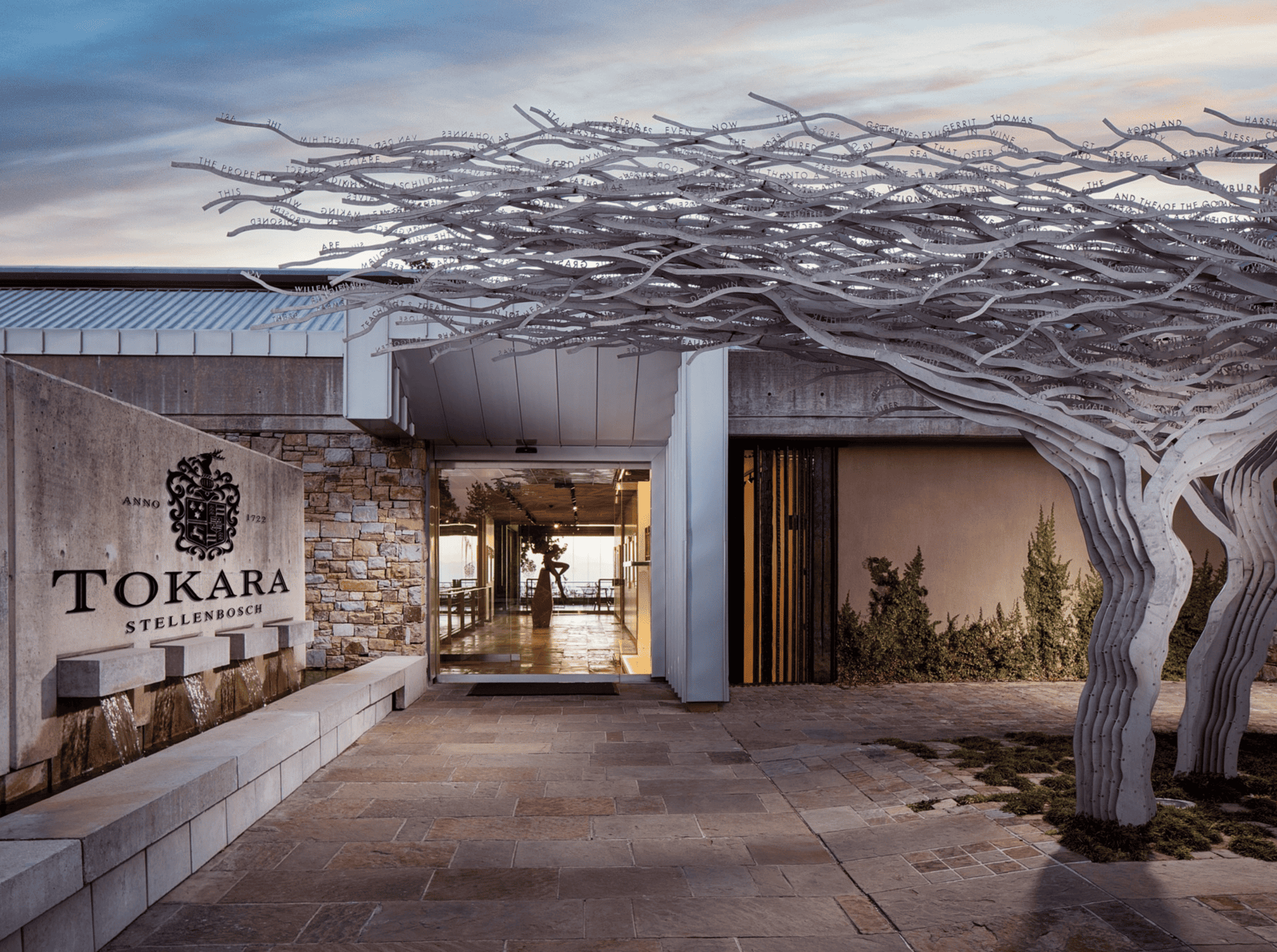 TOKARA Stellenbosch winery entrance with metal tree sculpture and fountain