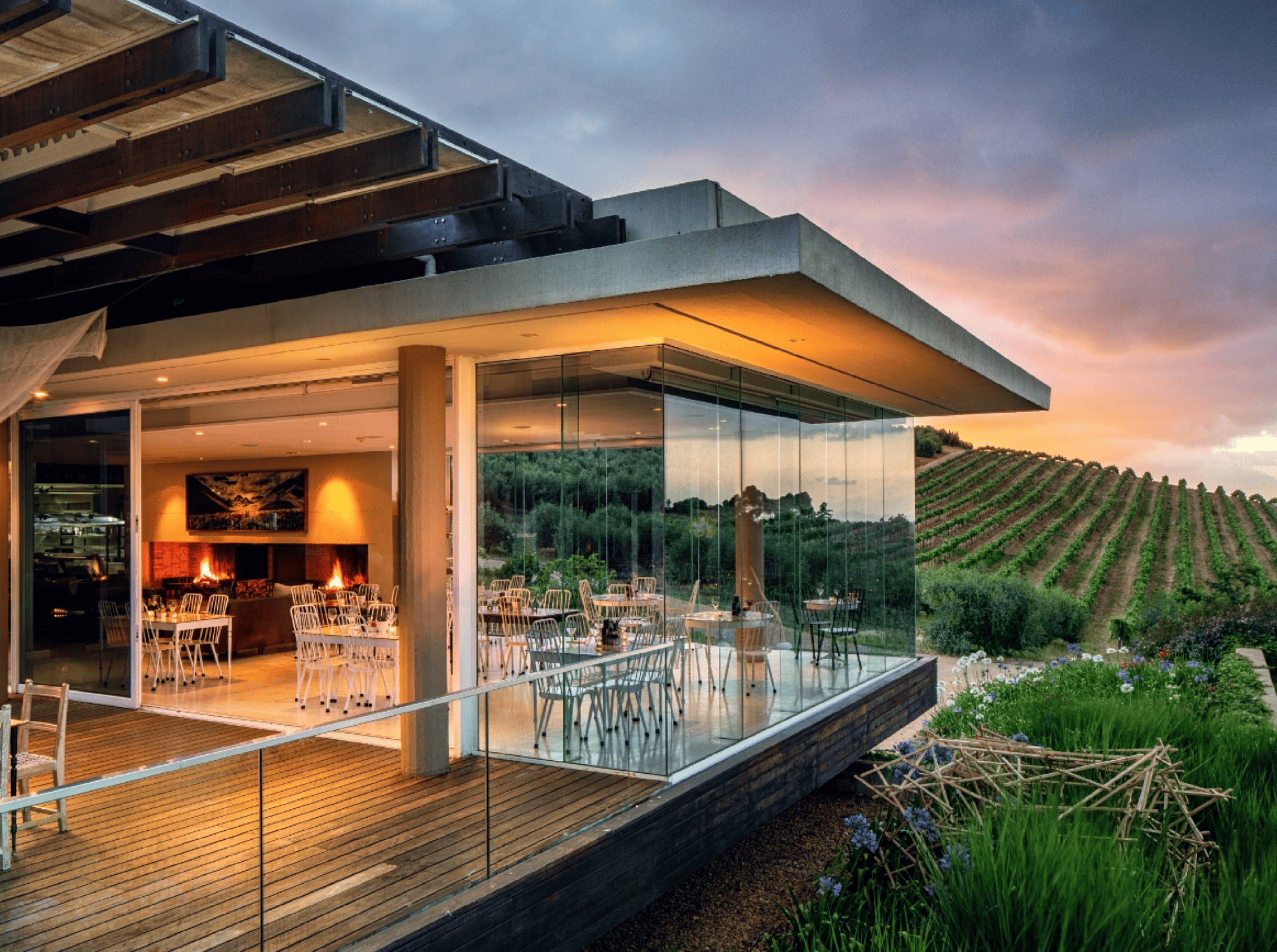 Modern winery restaurant with vineyard view at sunset